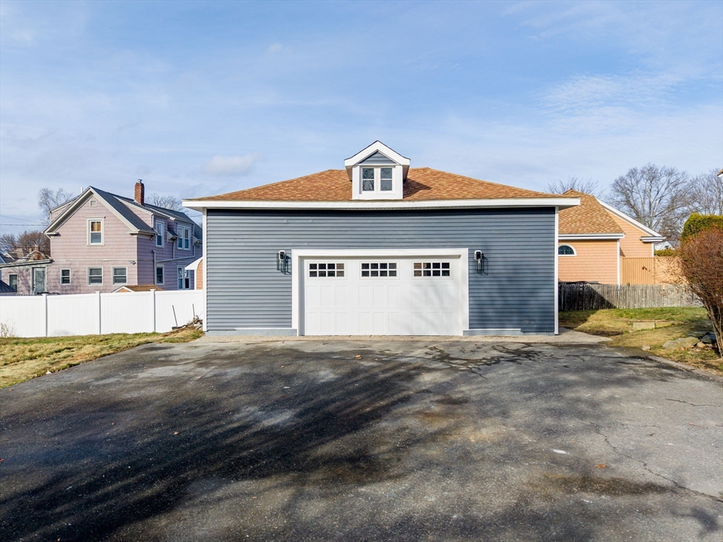 32 Cedar Street Fairhaven, MA 02719 - Photo 24 of 28 a view of a house with a yard and garage