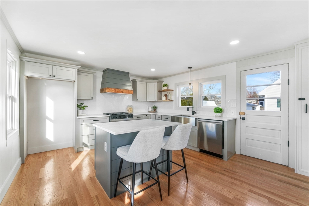 32 Cedar Street Fairhaven, MA 02719 - Photo 4 of 28 a kitchen with white cabinets and stainless steel appliances