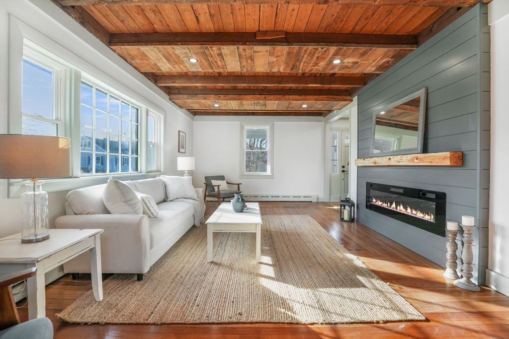 32 Cedar Street Fairhaven, MA 02719 - Photo 7 of 28 a living room with furniture and a fireplace