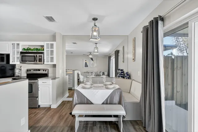 a living room with furniture a dining table and kitchen view