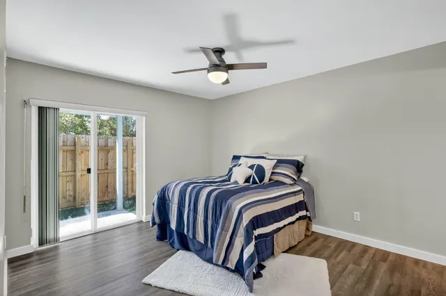 a bedroom with a bed and a ceiling fan