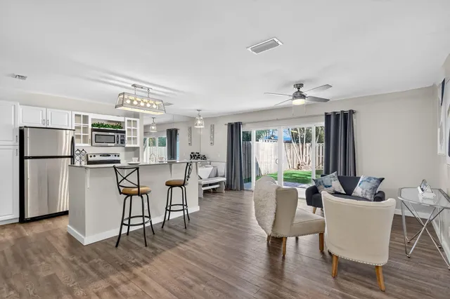 a living room with furniture and kitchen view