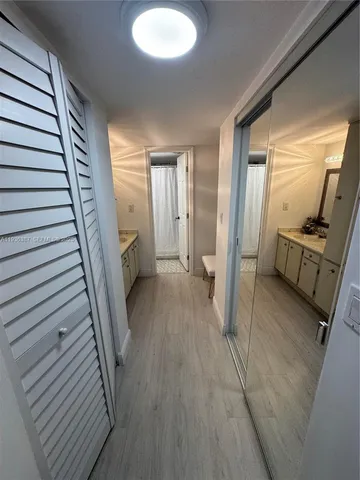 a view of a hallway view with wooden floor and staircase