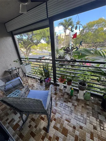 a room with furniture and a potted plant