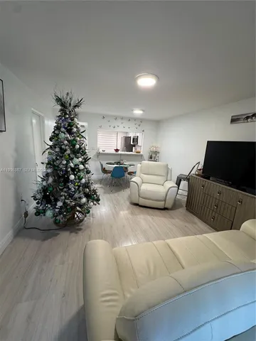 a living room with furniture potted plant and a window