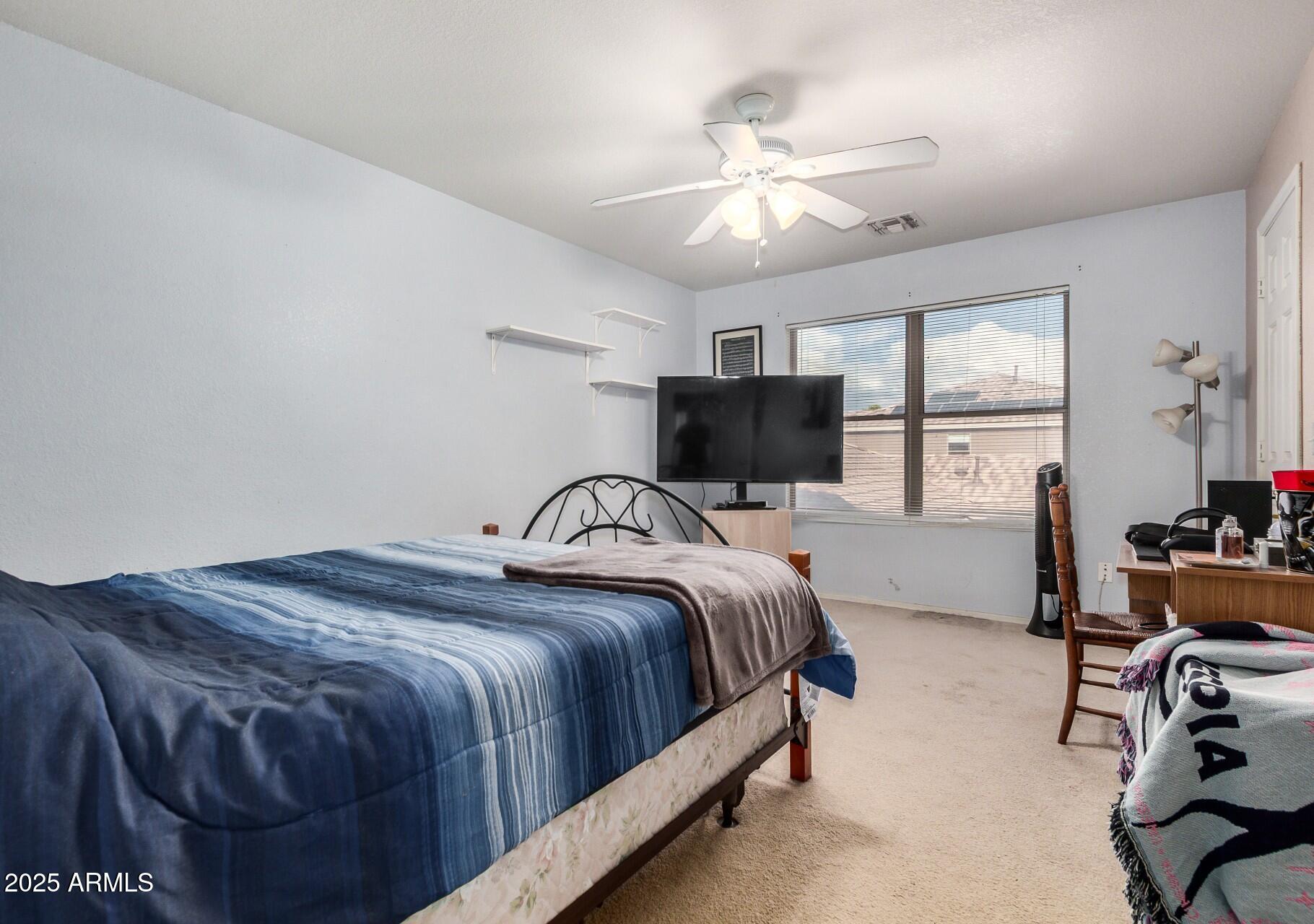 564 West Aviary Way Gilbert, AZ 85233 - Photo 17 of 29 a bedroom with a bed gym equipment and a window