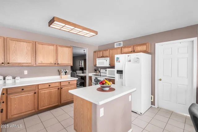 a utility room with cabinets washer and dryer
