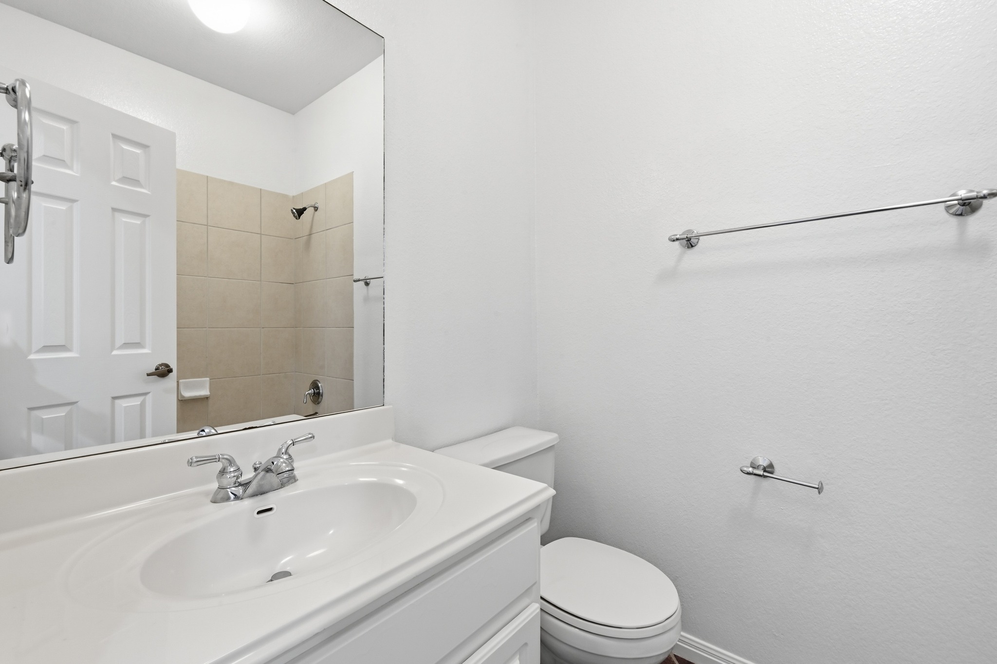 4508 Duval Road, Unit 4401 Austin, TX 78727 - Photo 19 of 26 Clean white walls and neutral tiled shower surfaces define this functional bathroom space.