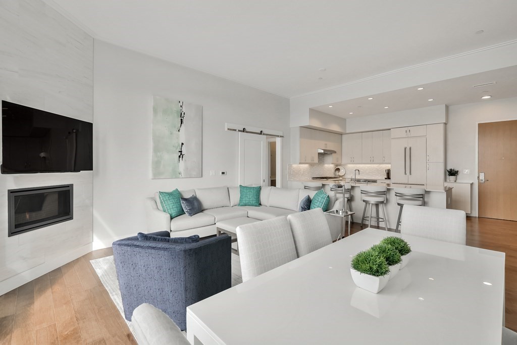 10 Shipyard Drive, Unit 510 Hingham, MA 02043 - Photo 13 of 40 a living room with furniture a flat screen tv and a fireplace