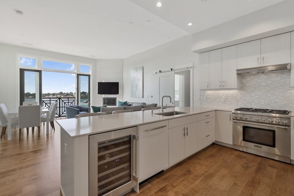 10 Shipyard Drive, Unit 510 Hingham, MA 02043 - Photo 17 of 40 a large kitchen with granite countertop a stove and a sink