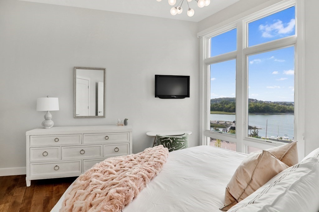 10 Shipyard Drive, Unit 510 Hingham, MA 02043 - Photo 30 of 40 a bedroom with a bed and a flat tv screen on the dresser