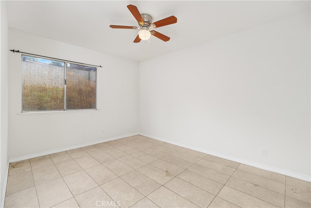 6897 Crest Avenue Riverside, CA 92503 - Photo 21 of 26 an empty room with a window and a ceiling fan