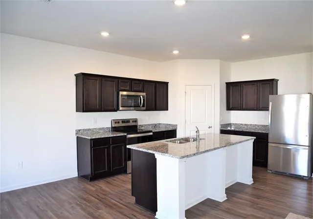a kitchen with a sink stove and refrigerator