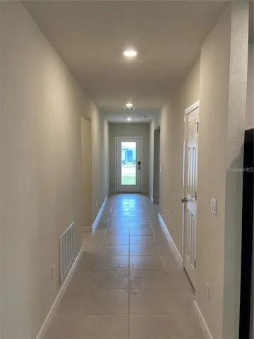 a large kitchen with kitchen island a sink a stove and a refrigerator