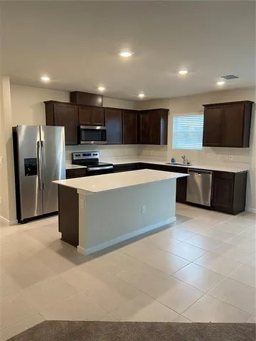 a kitchen with a refrigerator and a sink