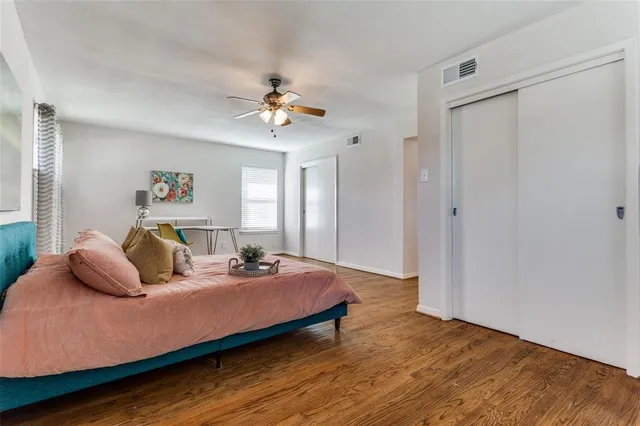 a bedroom with a bed and wooden floor