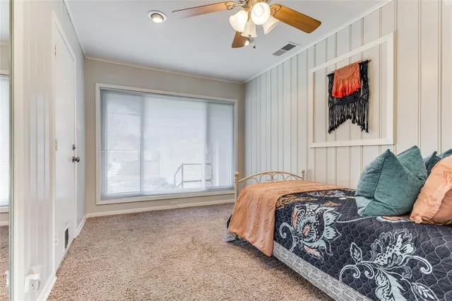 a bed sitting in a bedroom next to a window