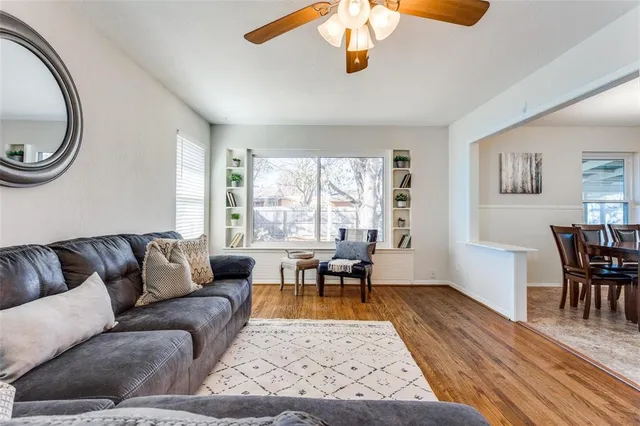 a living room with furniture wooden floor and a window