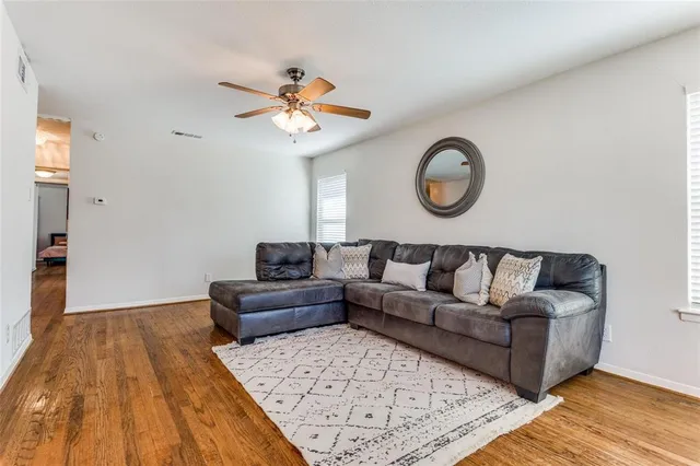 a living room with a couch and chandelier