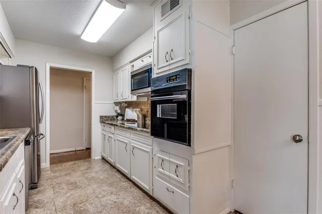a kitchen with stainless steel appliances a stove a microwave and a refrigerator