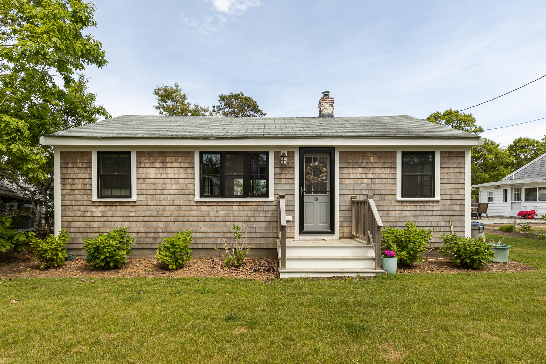 16 Edwards Road Dennis Port, MA 02639 - Photo 1 of 46 a front view of a house with a yard