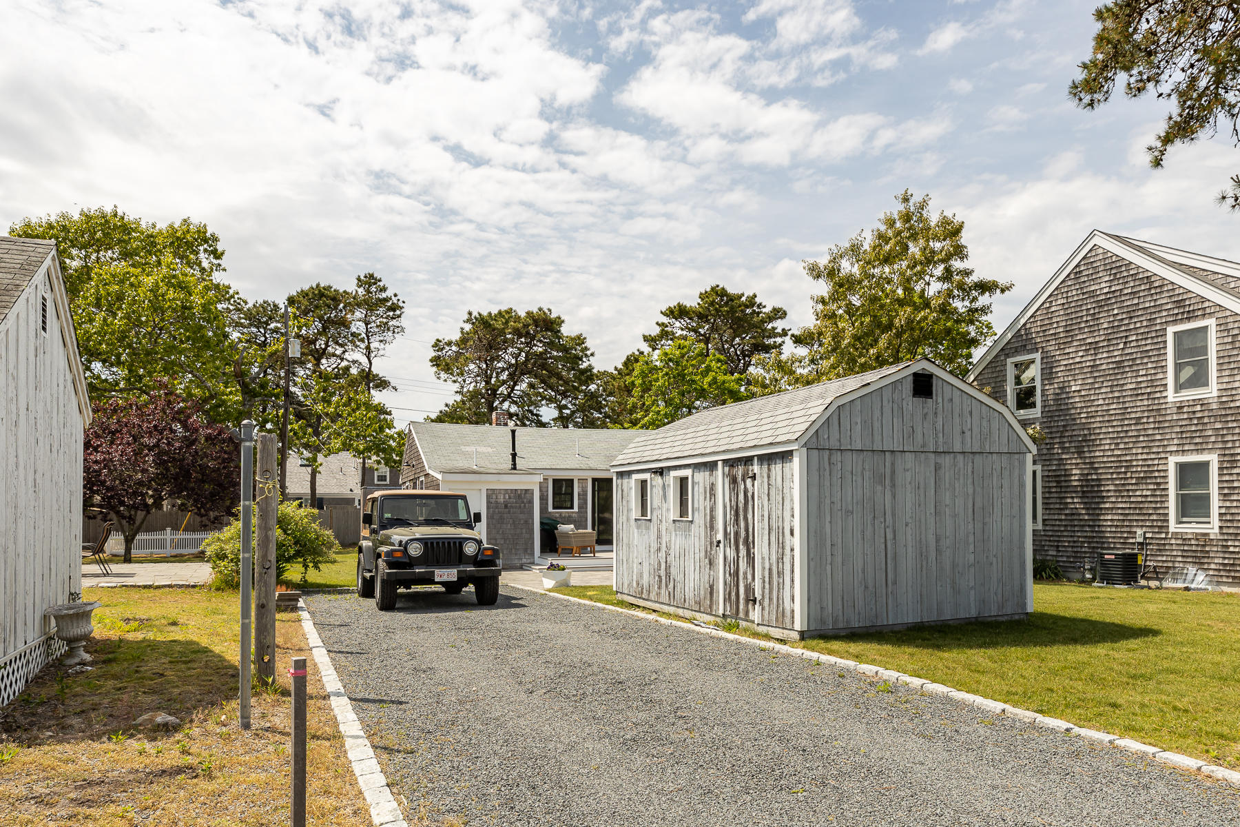 16 Edwards Road Dennis Port, MA 02639 - Photo 12 of 46 a view of a house with a big yard and large trees