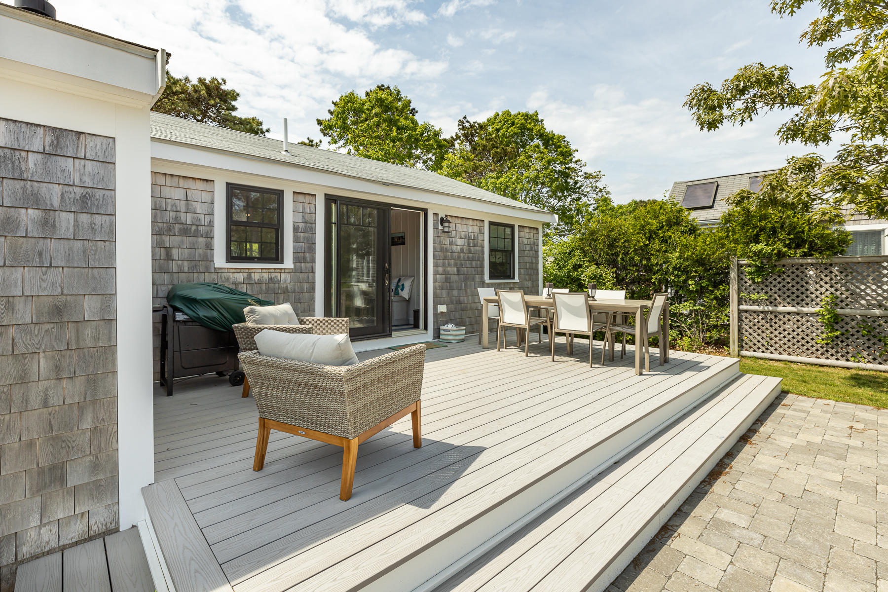 16 Edwards Road Dennis Port, MA 02639 - Photo 9 of 46 a view of a patio with couches table and chairs with wooden floor and fence