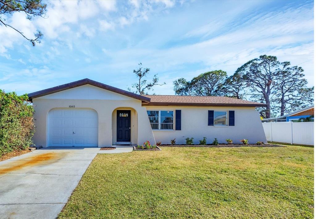 1065 Fundy Road Venice, FL 34293 - Photo 1 of 1 a front view of house with yard and trees in the background