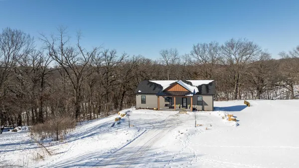 a white house that has a tree in front of it