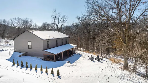 a kitchen with stainless steel appliances granite countertop a refrigerator a stove top oven a sink dishwasher and white cabinets with wooden floor