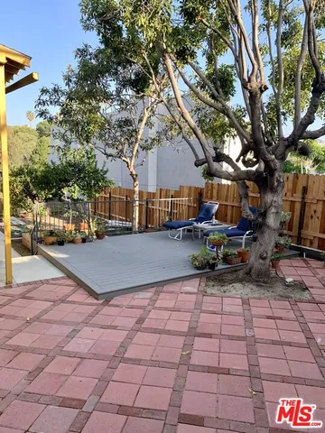 a view of a patio with table and chairs and potted plants