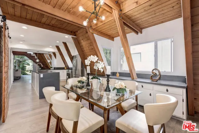 a very nice looking dining room with a large window and dining table