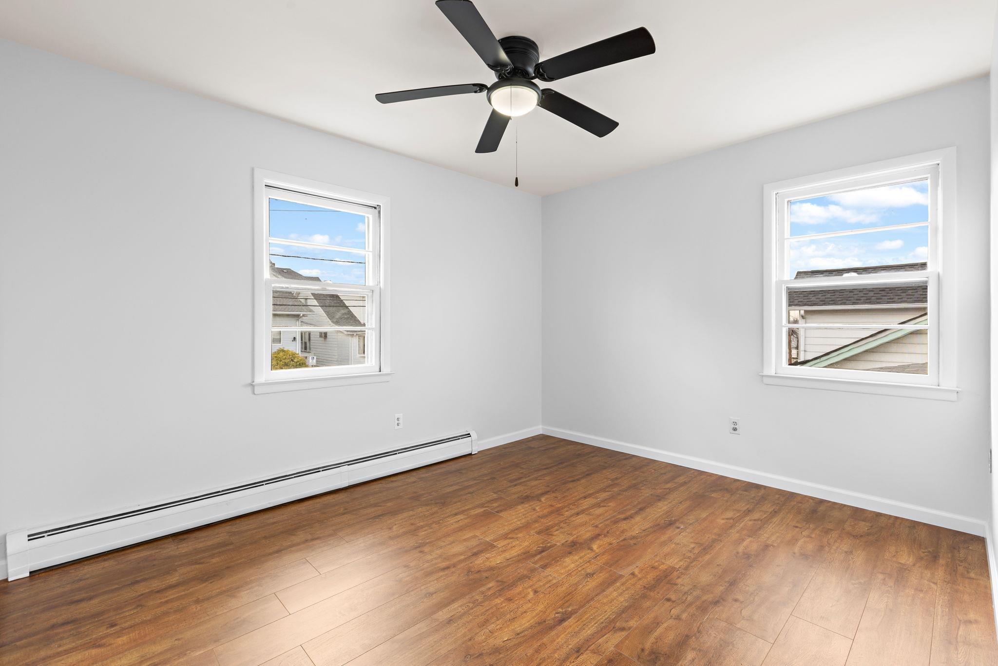 70 2nd Avenue, Unit 2 Secaucus, NJ 07094 - Photo 11 of 14 a view of empty room with wooden floor and fan