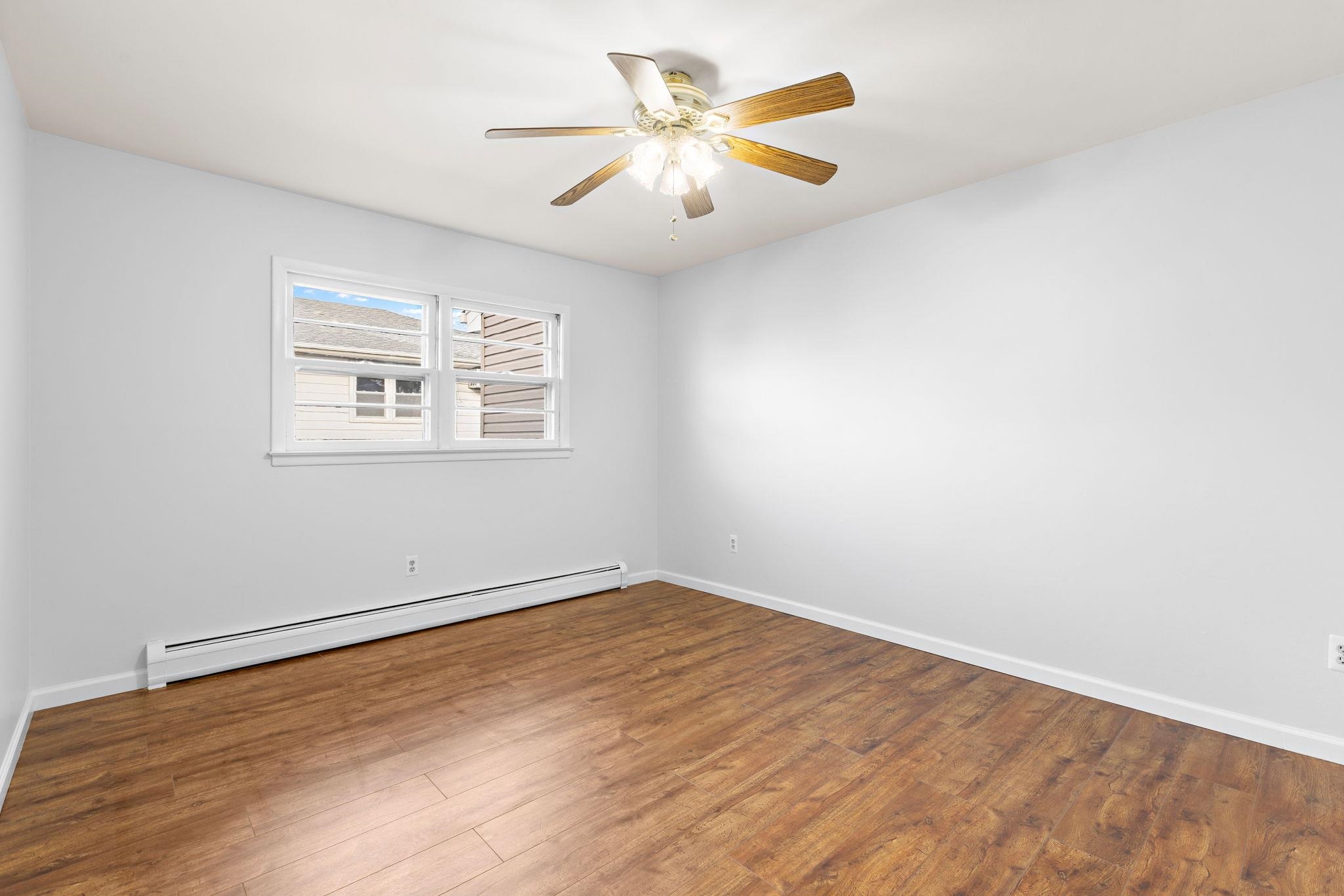 70 2nd Avenue, Unit 2 Secaucus, NJ 07094 - Photo 13 of 14 an empty room with a window and a ceiling fan