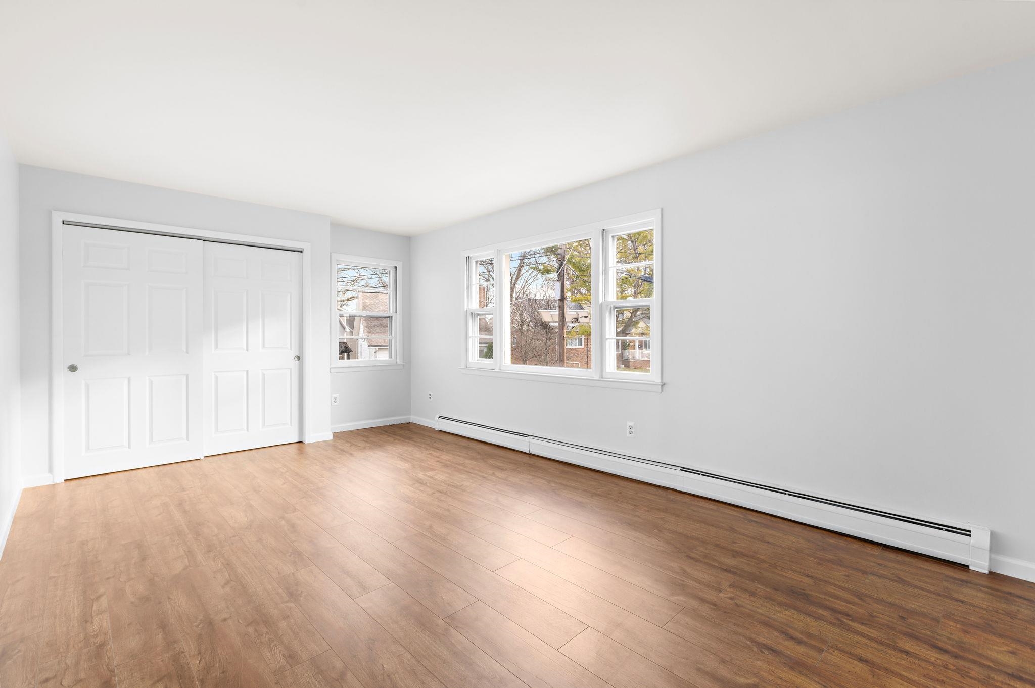 70 2nd Avenue, Unit 2 Secaucus, NJ 07094 - Photo 3 of 14 an empty room with wooden floor and windows