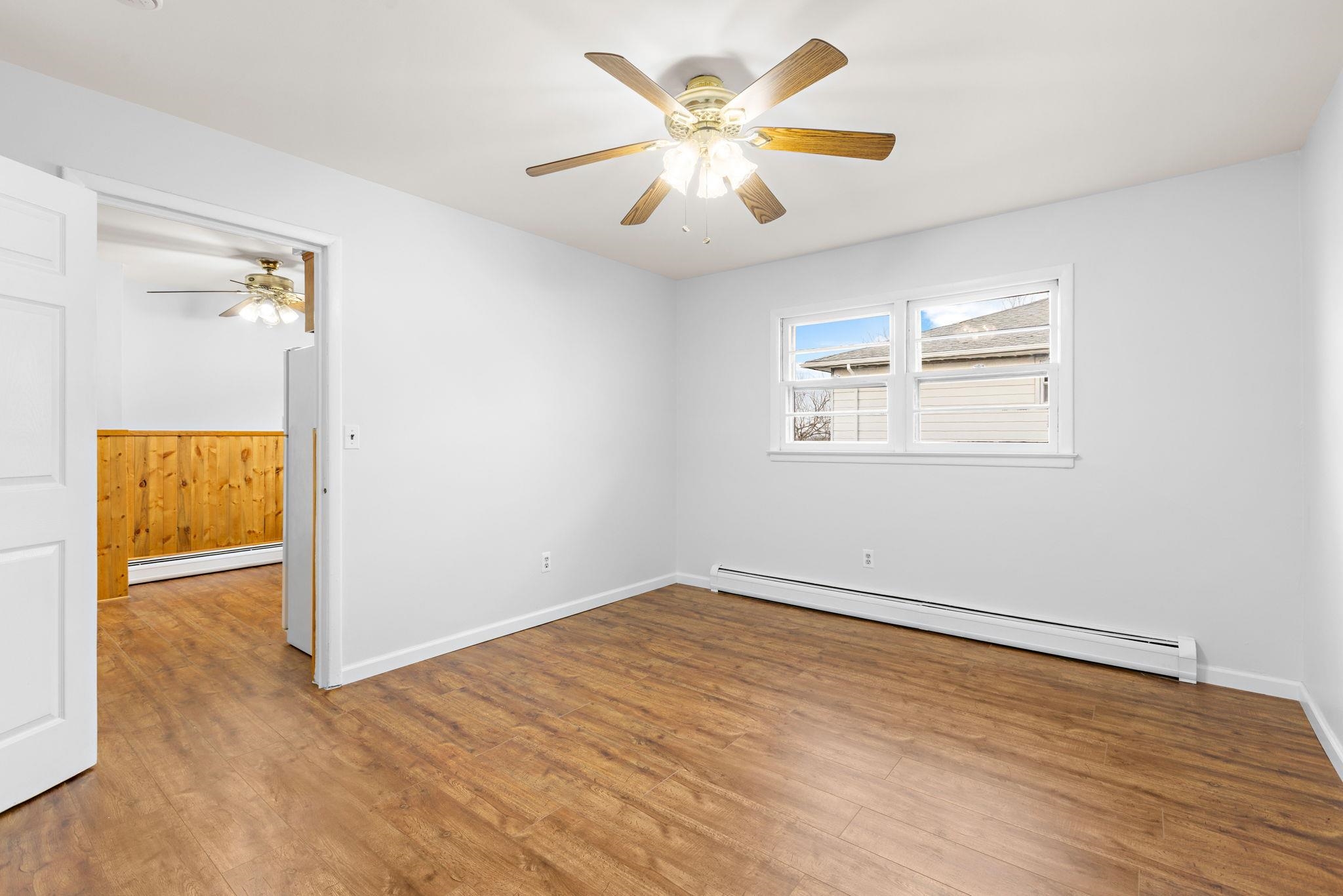 70 2nd Avenue, Unit 2 Secaucus, NJ 07094 - Photo 4 of 14 wooden floor in an empty room with a window