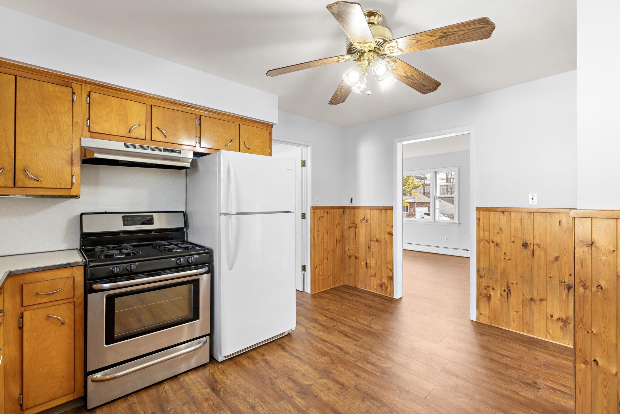 70 2nd Avenue, Unit 2 Secaucus, NJ 07094 - Photo 5 of 14 a kitchen with granite countertop a refrigerator stove and cabinets