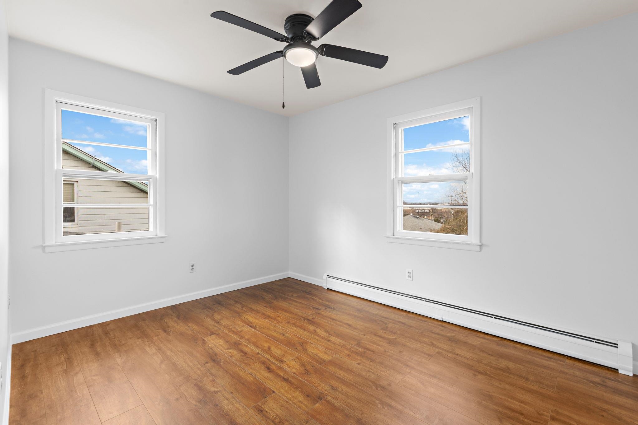 70 2nd Avenue, Unit 2 Secaucus, NJ 07094 - Photo 9 of 14 a view of empty room with wooden floor and fan