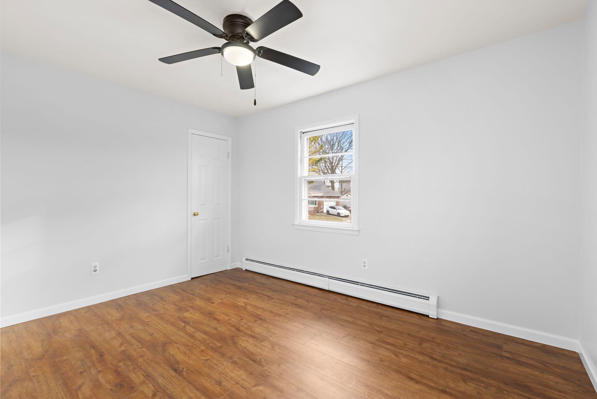 70 2nd Avenue, Unit 2 Secaucus, NJ 07094 - Photo 10 of 14 an empty room with wooden floor and windows