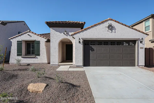 a front view of a house with a yard and garage
