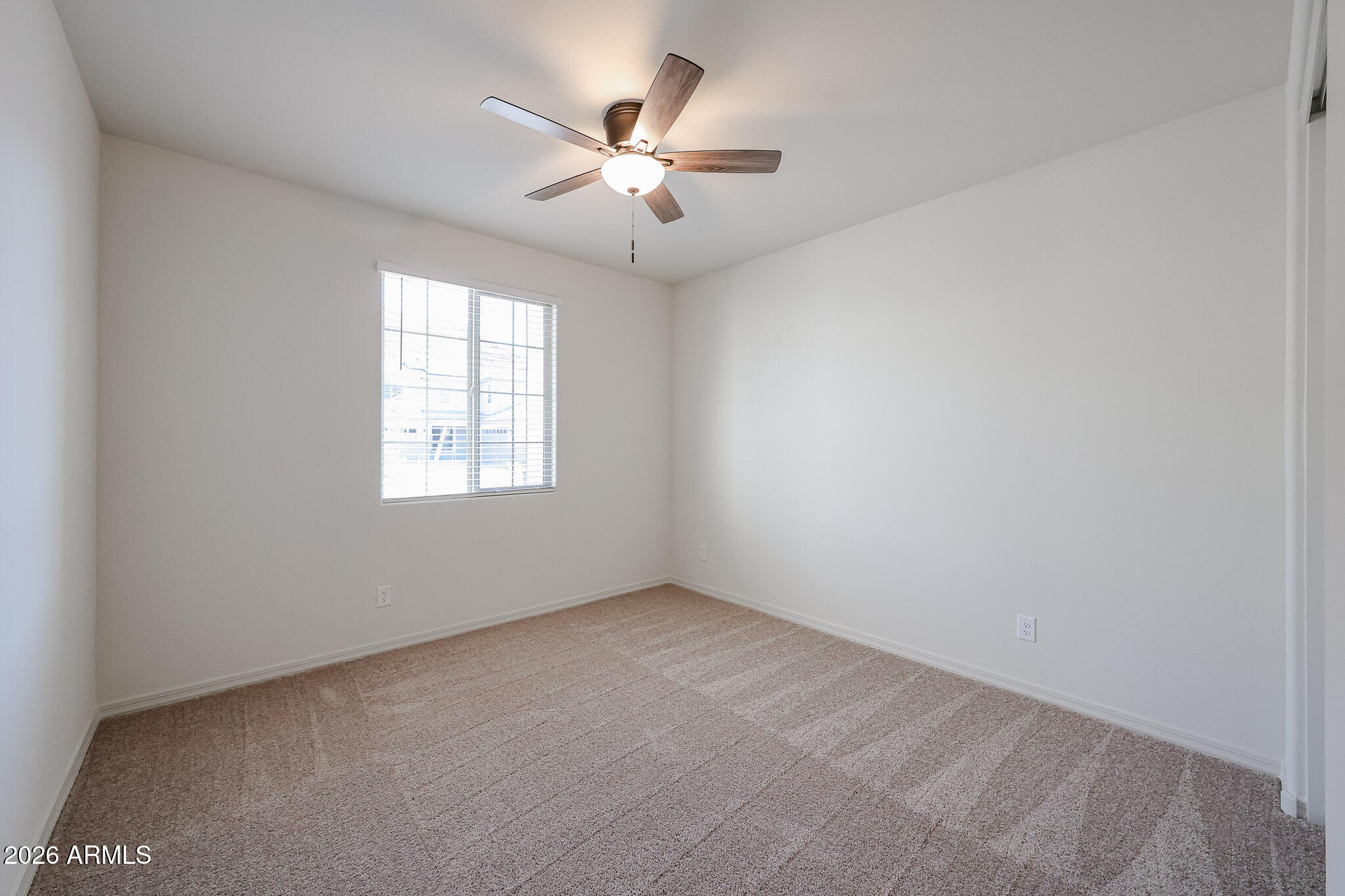 7023 West Plum Road Peoria, AZ 85383 - Photo 13 of 22 an empty room with a window and a fan