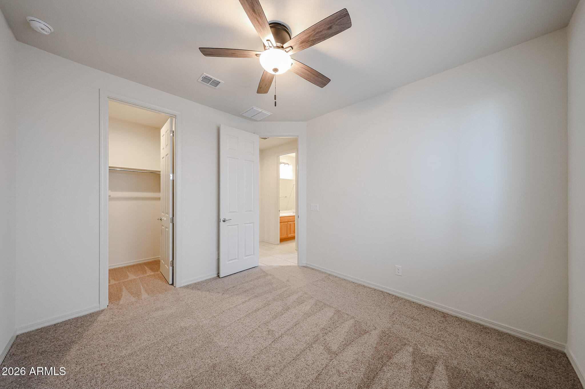 7023 West Plum Road Peoria, AZ 85383 - Photo 14 of 22 an empty room with ceiling fan and window