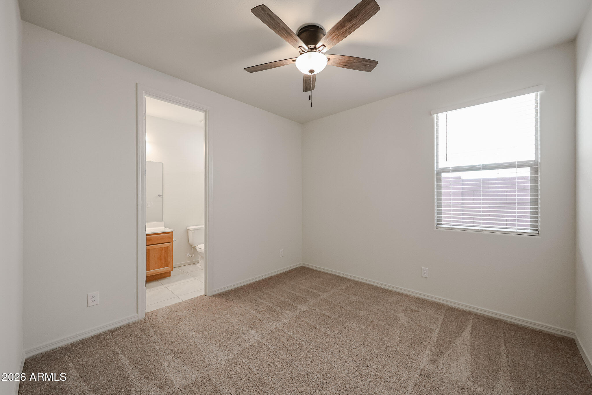 7023 West Plum Road Peoria, AZ 85383 - Photo 16 of 22 an empty room with a window and a fan