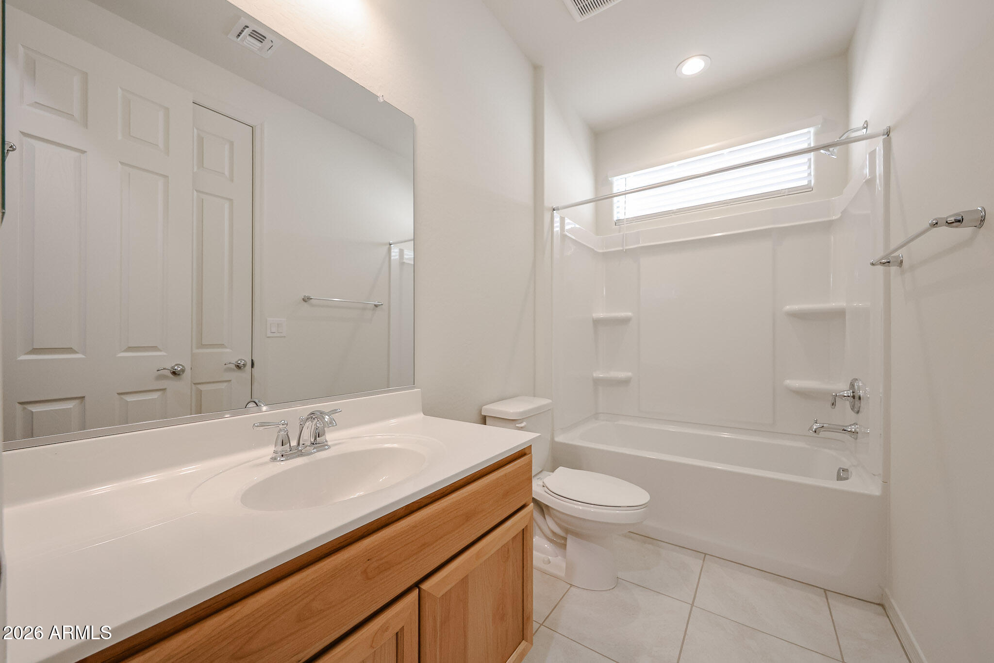 7023 West Plum Road Peoria, AZ 85383 - Photo 17 of 22 a bathroom with a granite countertop sink a toilet and bathtub