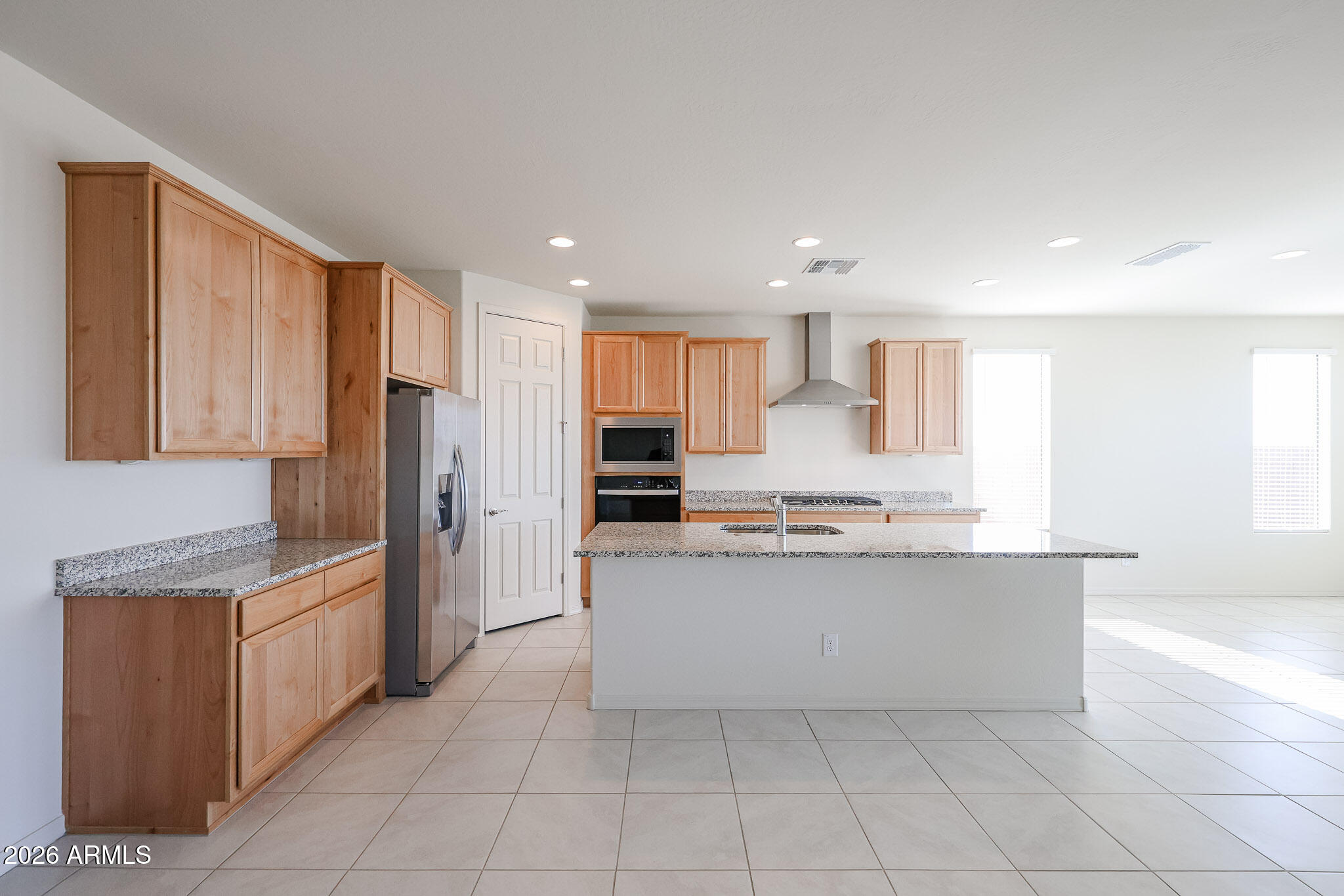 7023 West Plum Road Peoria, AZ 85383 - Photo 2 of 22 a kitchen with stainless steel appliances a refrigerator sink and cabinets