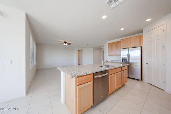 a kitchen with stainless steel appliances granite countertop a sink and cabinets