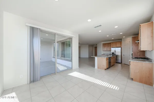 a large kitchen with stainless steel appliances a refrigerator and a stove top oven