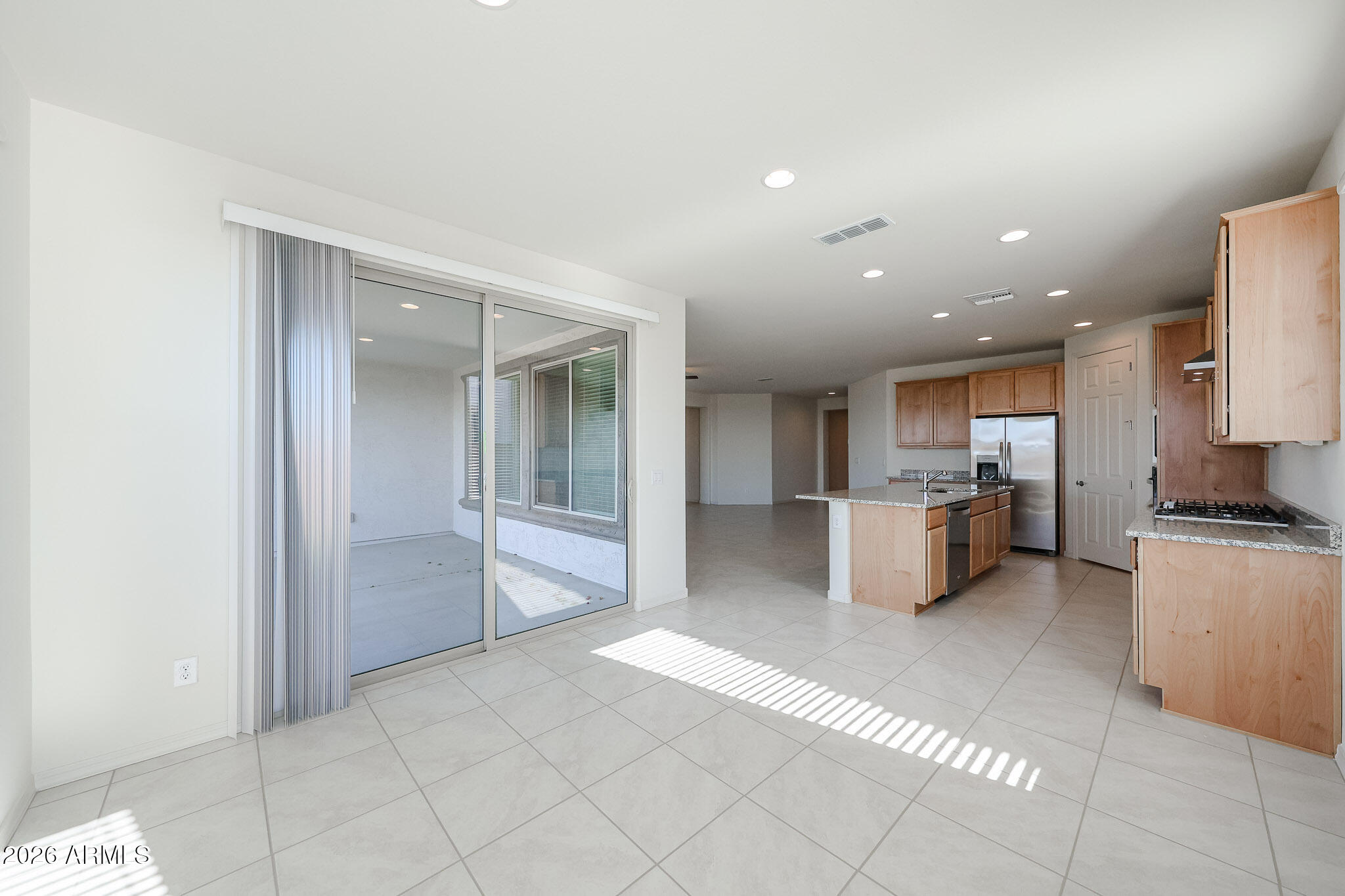 7023 West Plum Road Peoria, AZ 85383 - Photo 5 of 22 a large kitchen with stainless steel appliances a refrigerator and a stove top oven