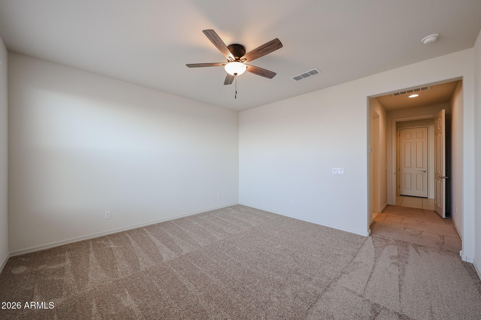 7023 West Plum Road Peoria, AZ 85383 - Photo 8 of 22 an empty room with closet and ceiling fan