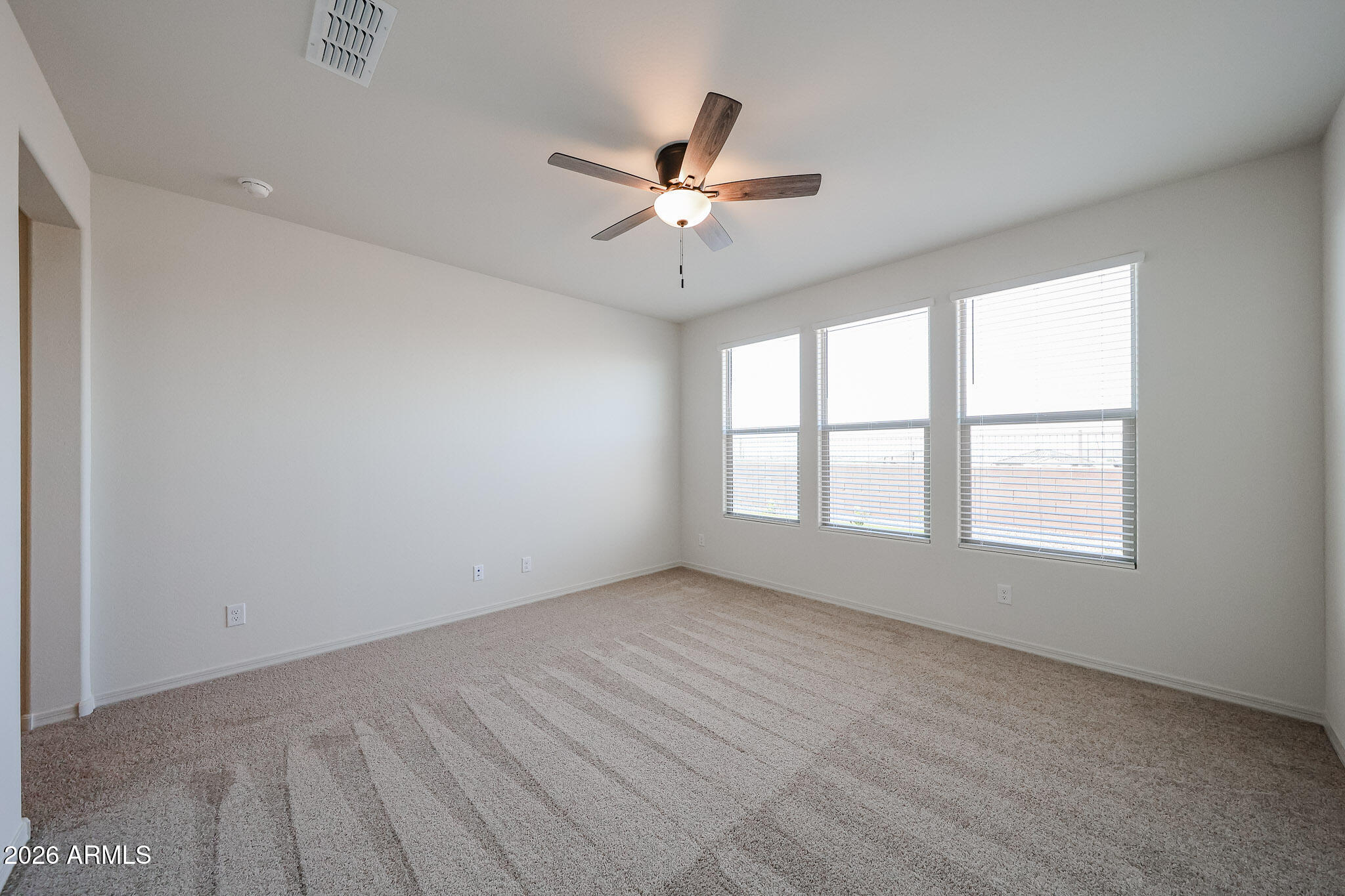 7023 West Plum Road Peoria, AZ 85383 - Photo 9 of 22 wooden floor in an empty room with a window